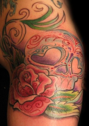 The feminine sugar skull with a rose tattoo design on shoulder and arm