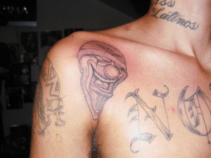 ... looking clown is inked above the armpit, in this gangsta tattoo