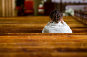 young woman praying in church