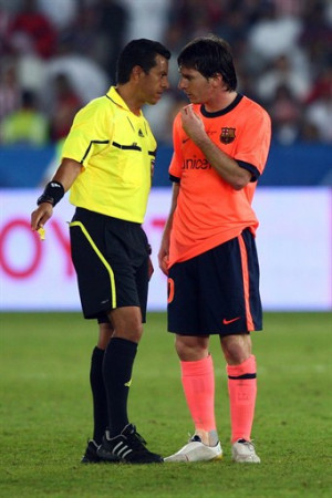 Lionel Messi of FC Barcelona talks to referee Benito Archundia