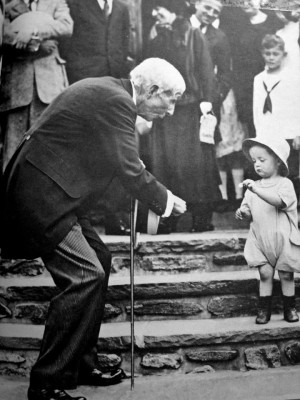 John D. Rockefeller, Sr. gives a nickel to a child on his 84th ...