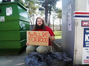 homeless people holding funny sign