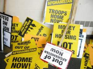 Multiple anti-war signs with pro-peace quotes left in a pile near the ...