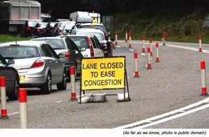 ... silly sign and funny road work sign: Lane closed to ease congestion