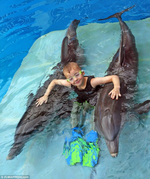 Dream come true: Cieran Kelso sits with Winter the tail-less dolphin ...