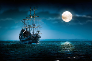 One beautiful pirate ship sailing in blue ocean by the bright full ...