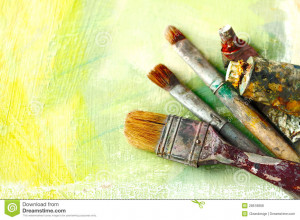 Vintage artists brushes and paint tubes on an abstract artistic ...