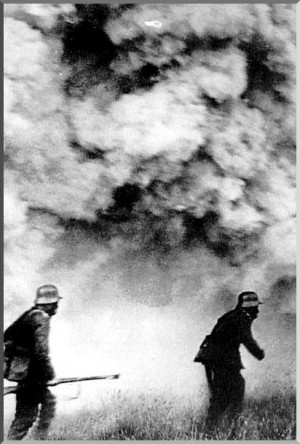 Wearing gas masks, German soldiers wade through a gas attack by the ...
