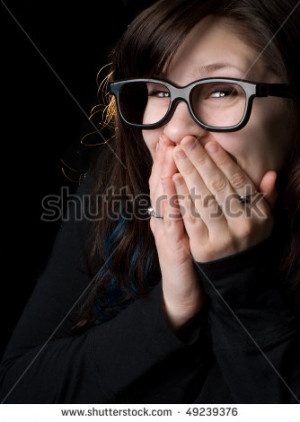 dorky girl with goofy glasses on black background. - stock photo