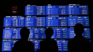 ... look at a stock quotation board at the Tokyo Stock Exchange in Tokyo