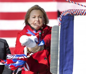 Susan Ford Bales swings the champagne bottle