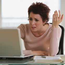 frustrated-woman-using-her-laptop-250-thumb-250×250