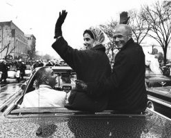 Annie and John Glenn wave to the crowd during a Washington, DC parade ...