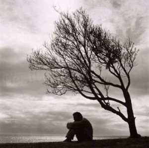 boy sitting on sea shore alone in love