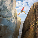 person jumping over a deep chasm