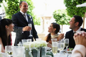 Best man toasting champagne to bride and groom at table - Maria ...