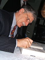 Dallaire signing copies of his book Shake Hands with the Devil .