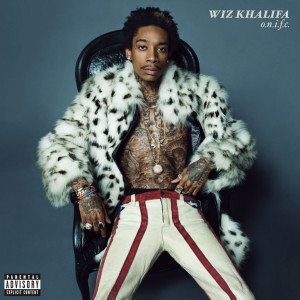 Wiz Khalifa sits comfortably with his snow leopard fur coat on, for ...