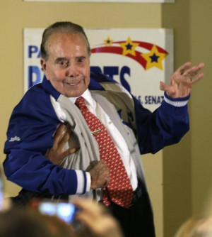 Former Sen Bob Dole waves to the crowd during a rally in support of