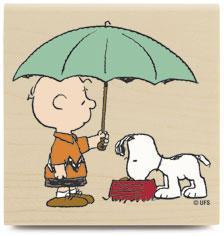 ... charlie brown holds an umbrella for snoopy while snoopy eats his