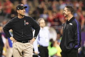 Jim Harbaugh and John Harbaugh talk on the field before Super Bowl ...
