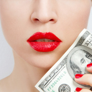 Woman with bright red lips holding 100 dollar bill web