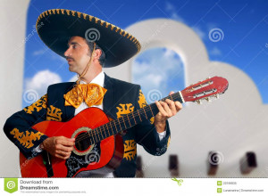 Royalty Free Stock Photo: Charro Mariachi playing guitar Mexico houses