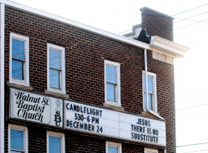 The sign at Walnut Street Baptist Church hangs on the side of the ...