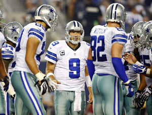 Dallas Cowboys quarterback Tony Romo (9) talks during a huddle in ...