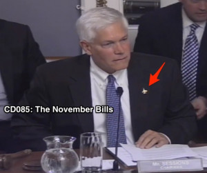 Rep. Pete Sessions shows of his fighter jet pin, which reminds him of ...