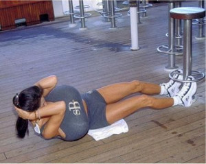 Woman with huge boobies is exercising.