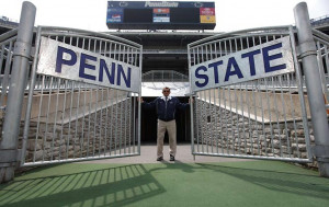 Joe Paterno opens the gates onto the field at Beaver Stadium.