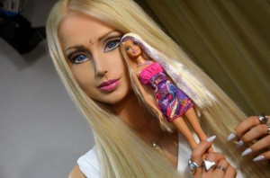 The Ukrainian model holds up a Barbie doll, the inspiration for her ...
