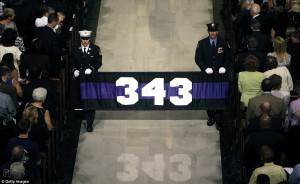 343: Firefighters carry a banner with the number of firefighters ...