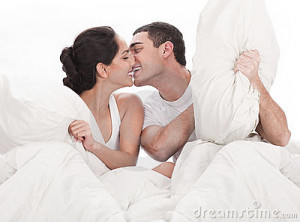 Couple kissing and playing on bed in bedroom, in passion over white ...