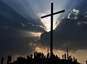 People wait for a re-enactment of Jesus' crucifixion during Holy Week ...
