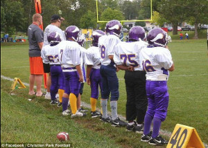 Respect: Christian Park football players wait on the sidelines. The ...