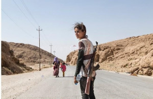... girl carries an assault rifle to protect her family against ISIS