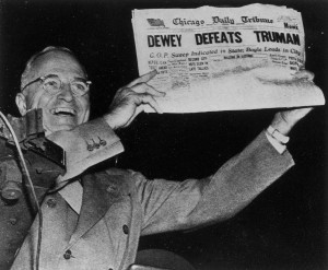 President Harry S. Truman holds up the newspaper which has the ...