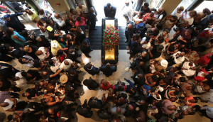 Image: The casket is removed from the church following the funeral ...
