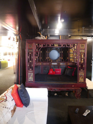 An antique Chinese wedding bed dominates the library area of the loft.