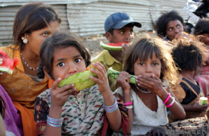 impoverished children eating watermelon