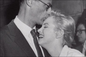 Marilyn Monroe leans against her fiance, playwright Arthur Miller, as ...