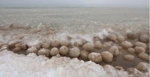 Ice balls rolling up on the shore of Lake Michigan