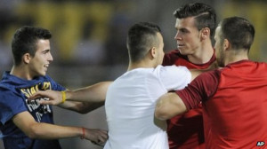 Gareth Bale is accosted by two fans during the World Cup qualifier in
