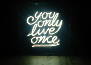You only live once” quote written in neon lights