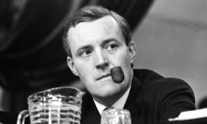 Tony Benn puffs on his pipe as he listens to speeches during the ...