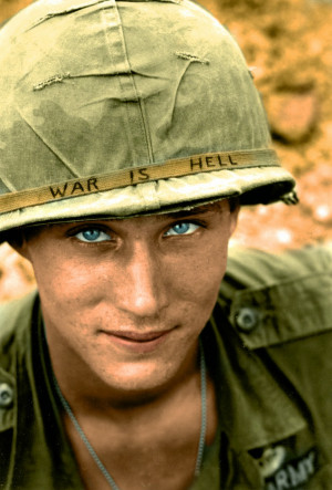 An American soldier wears a hand lettered “War Is Hell” slogan on ...