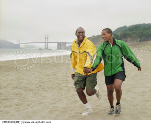 Couple Jogging Along Beach