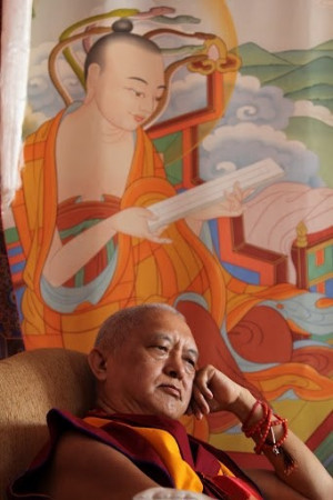 Lama Zopa, deep in thought, with Nagarjuna over head.